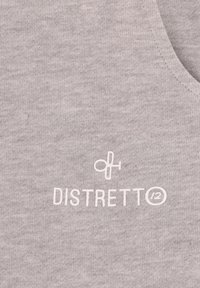 Canotta in tessuto grigio chiaro con texture liscia e logo "DISTRETTO" stampato in bianco, posizionato verso il basso a sinistra.