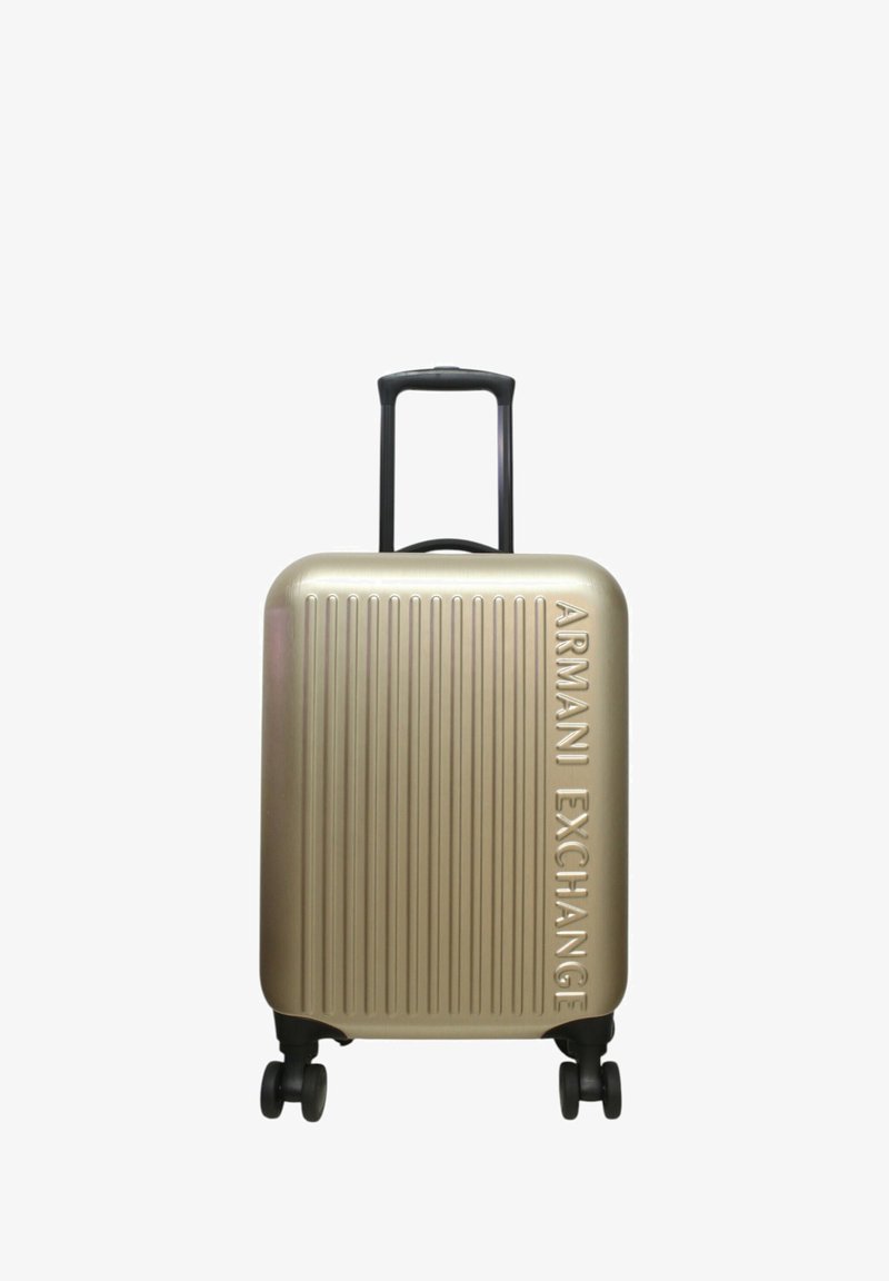 Valigia rigida dorata con design a righe verticali e marchio in rilievo "Armani Exchange". Manico retrattile e quattro ruote nere.