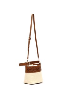 Sac à main marron et crème avec une bande en cuir perforé, texture tressée, bandoulière réglable et fermeture à cordon à l'intérieur.