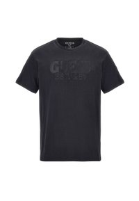 Sort T-shirt med korte ærmer og rund hals med prægede "GUESS EST. 1981" tekst på brystet.