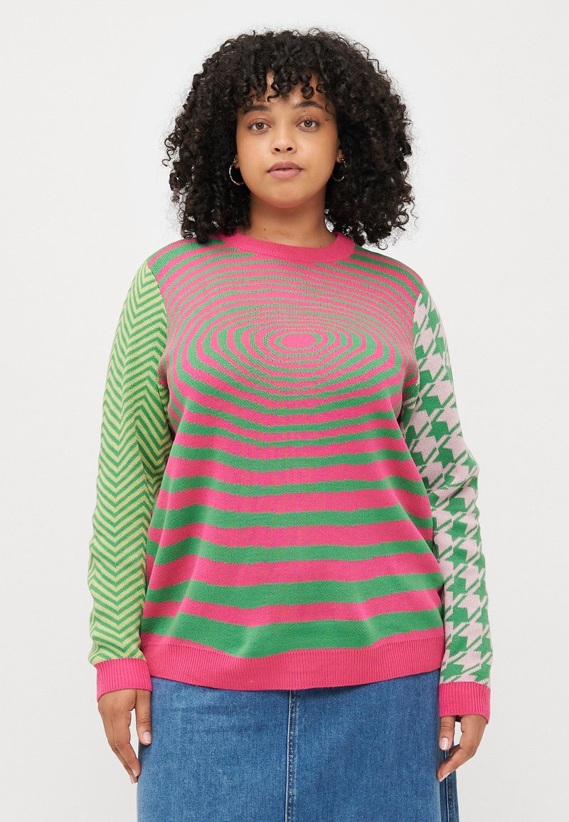 Multicolored knit sweater featuring horizontal pink and green stripes. Left sleeve has a zigzag pattern, while the right displays a houndstooth design.