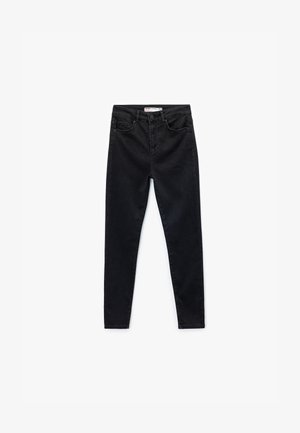 Jeans skinny neri in denim, con vita media, tasche frontali e una consistenza liscia e morbida senza decorazioni evidenti.