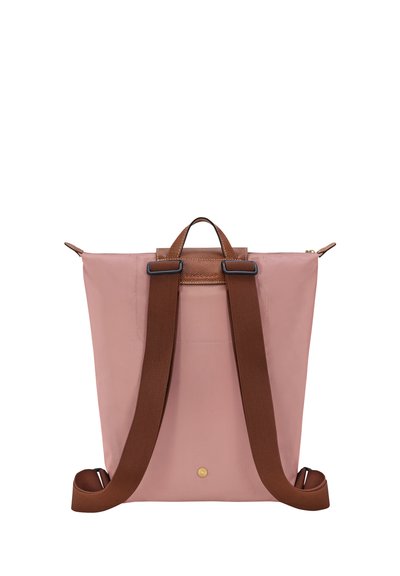 Pink nylon backpack with brown leather accents. Features adjustable straps, top handle, and a zipper closure. Clean design, no patterns.