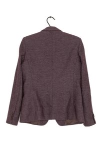 Blazer in tweed marrone appeso a una gruccia nera, visto da dietro, con maniche lunghe e polsini abbottonati su sfondo bianco.