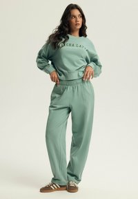 KEITHAN BLOOVII - Tracksuit bottoms - mint