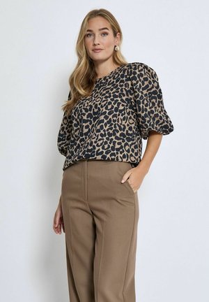 Leopard print blouse in tan and black, featuring short puff sleeves and a relaxed fit, paired with high-waisted brown trousers.
