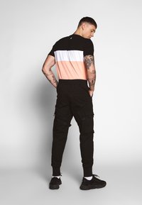 Urban Classics TACTICAL TROUSER - Cargo trousers - black
