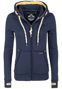 Sweat à capuche zippé navy avec doublure intérieure jaune contrastée, cordons blancs et deux poches avant ; présente une étiquette de marque et des boutons décoratifs.