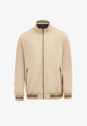 Beige jakke med opretstående krave, lynlås foran, to lynlåslommer i siderne og stripet ribbet manchetter og kant. Glat stofstruktur.