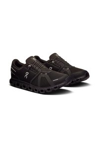 Schwarze Sportschuhe aus Mesh und Gummi. Verfügen über eine strukturierte Sohle, Logoapplikationen und ein Schnürdesign mit verstärkten Bereichen.