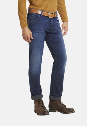 Dark blue denim jeans with a straight cut, featuring minimal fading and five-pocket design, paired with brown lace-up boots.