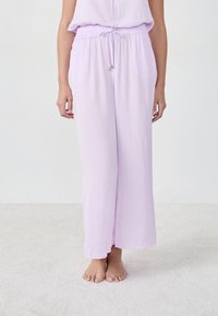 Lichtpaarse wijde broek gemaakt van zachte, gestructureerde stof met een elastische tailleband en strikdetail, met een relaxte pasvorm.