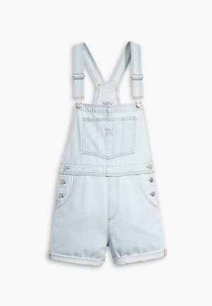 Lyseblå denim kort overall med justerbare stropper, en lomme foran på brystet, knapper i siden og opsmøgede manchetter.