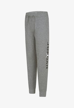 Gray sweatpants made of cotton blend with a tapered fit, featuring a black "JORDAN" logo and a white Jumpman accent on the side.