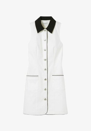 Vestido blanco sin mangas con cuello y ribete negro, con botones en la parte delantera y dos bolsillos laterales. Textura suave y diseño clásico.