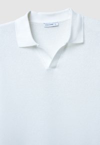 Polo shirt bianco in maglia con design a scollo a V, tessuto testurizzato e colletto piatto. L'etichetta mostra il marchio "CALLIOPE" e la taglia "L".