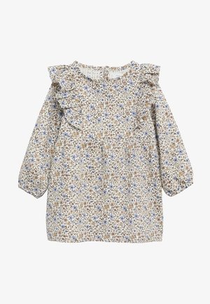 Bluse mit Blumenmuster und Ballonärmeln, die einen rüschierten Ausschnitt hat. Die Farben umfassen Creme, Blau und Braun auf einem hellen Hintergrund.