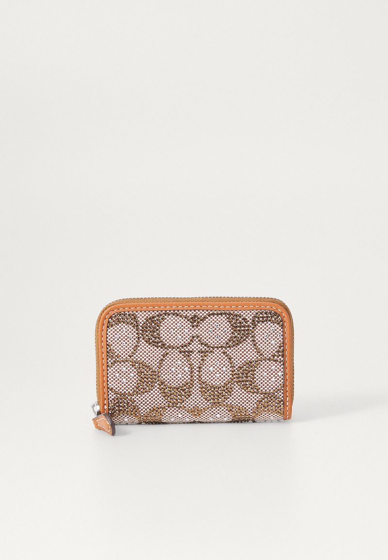 Portefeuille compact avec un design en maille rose, orné de motifs circulaires bruns et d'une garniture en cuir orange. Fermeture zippée avec un petit onglet.