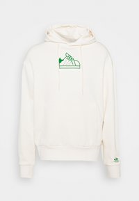 Crème hoodie met een kangoeroezak, voorzien van een groen sneaker graphic op de borst en een groen merklogo op de mouw. Zachte textuur.