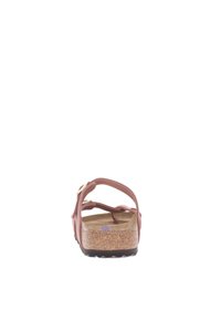 Brown cork sandal with soft pink straps, adjustable with buckles, featuring a textured insole and a contoured footbed for support.