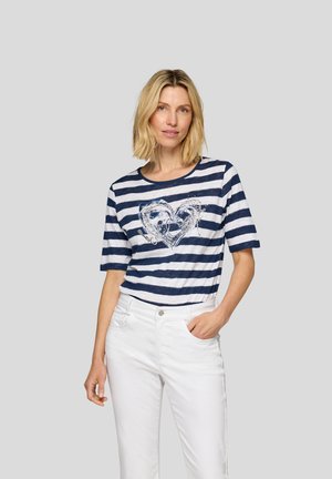 Navy and white striped t-shirt with a round neck and short sleeves, featuring a heart graphic with decorative accents. Worn with white pants.