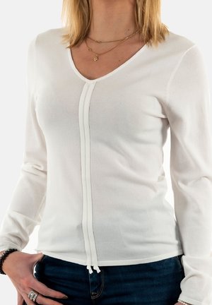 Witte lange mouwen top met een V-hals en voornaaddetails, gemaakt van lichte stof. Bevat een trekkoordszoom en een aansluitend ontwerp.