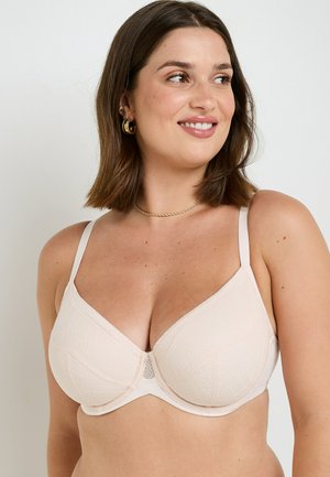 Soutien-gorge beige avec un design texturé, doté de bonnets à armatures et de bretelles ajustables. Une bordure en dentelle souligne le bord supérieur pour ajouter une touche de détail.