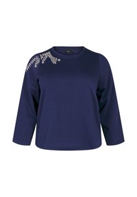 Mörkblå långärmad topp i mjukt tyg, med blommönster broderat på vänster axel. Rund halsringning och avslappnad passform.
