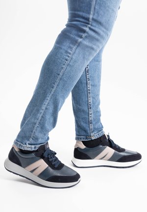 Sporty sneakers feature a mix of navy suede and leather, with light gray accents and a white sole. Laced design with cushioned ankle support.