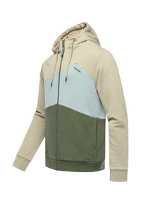 Sweat à capuche zippé en beige, bleu clair et vert olive. Présente un design coloré, un cordon de serrage et des poignets côtelés. Texture douce.