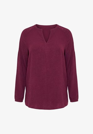 Halenka s dlouhým rukávem v hluboké červené barvě s rozparkem u kulatého výstřihu a volným střihem, vyrobená z texturované látky.