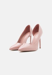 Ροζ γόβες από πατεντέ δέρμα με μυτερή μύτη και λεπτό τακούνι στιλέτο, με λείο τελείωμα και απαλό εσωτερικό επένδυση.