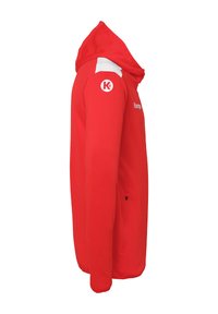 Red hooded jacket featuring a soft fabric, white accents on the shoulders, and a zippered pocket. Logo on the sleeve adds detail.