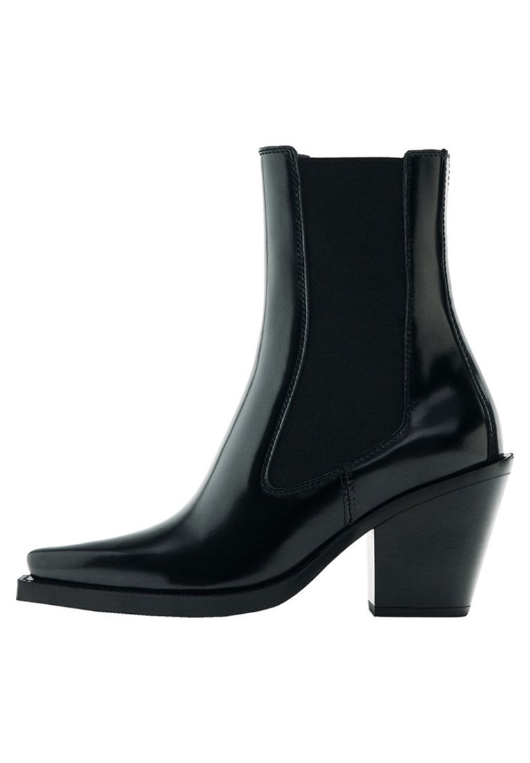 Black ankle boot made of glossy material, featuring elastic side inserts, a pointed toe, and a medium block heel for added support.