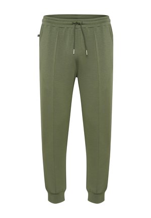 Jogging olive en vert fabriqués dans un tissu doux, avec une taille élastique et un cordon de serrage, des jambes fuselées et des poignets côtelés.