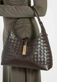 Brown woven leather handbag with a smooth base, gold hardware, and a zip closure. The structured shape features a single shoulder strap.