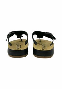Sandali neri con tomaia in pelle liscia, suola piatta e cinturino regolabile. Soletta imbottita con rivestimento beige, con logo del marchio.