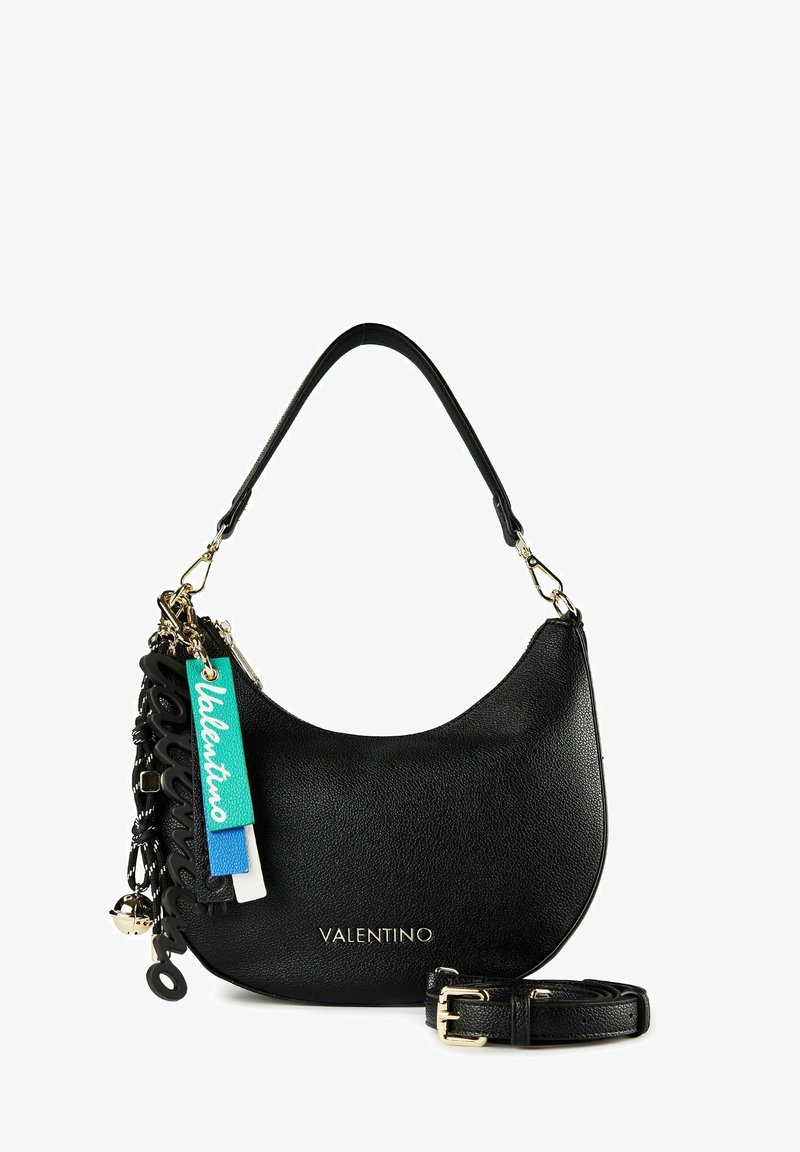 Zwarte leren Valentino-handtas met gebogen vorm, gouden beslag, decoratieve meerkleurige logo-labels en een afneembare band ernaast.