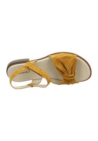 Yellow suede sandal with a knotted front design, open toe, and ankle strap. Features a flat heel and smooth interior lining.