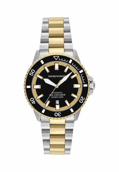Montre de plongée en métal bicolore argent et or avec cadran noir et or, marqueurs lumineux, affichage de la date et lunette tournante.