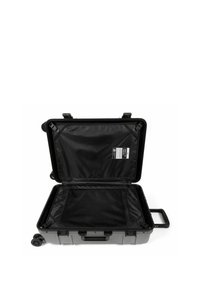 Valigia rigida nera con apertura con zip, scomparto in rete, manico robusto e quattro ruote per la mobilità. L'interno offre un ampio spazio di archiviazione.