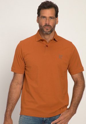 Kortærmet polo-shirt i rustorange, lavet af tekstureret stof. Har en to-knaps placket og et diskret logo på venstre bryst.