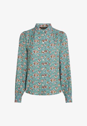 Chemise boutonnée teal avec impression florale, mettant en avant des fleurs roses, jaunes et blanches. Manches longues avec épaules froncées. Texture de tissu douce.