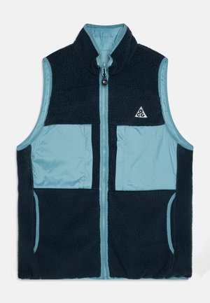 Fleece en nylon vest met hoge kraag, marineblauwe en lichtblauwe kleurblokken, ritssluiting aan de voorkant en twee zijzakken, met een logodetail.