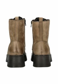 Botas de cuero marrón hasta el tobillo con un acabado texturizado, tacón grueso negro y cremalleras laterales para facilitara el uso. Detalle de costura a lo largo de las costuras.