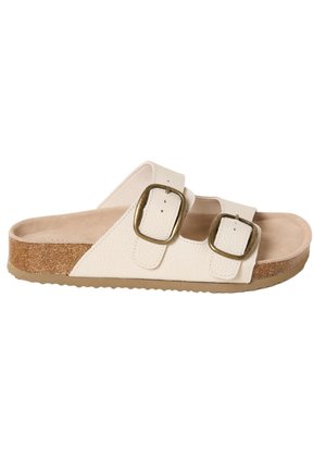 White slide sandal with cork sole, two adjustable straps, and large bronze buckles.