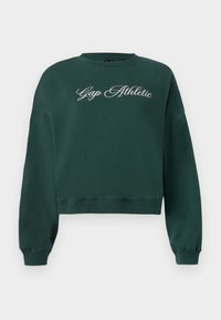 Dark green cropped sweatshirt with long sleeves and "Gap Athletic" embroidered in white cursive across the chest.