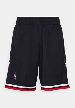 Black basketball shorts made of breathable mesh fabric, featuring a red and white stripe at the hem and NBA logo embroidered on the side.