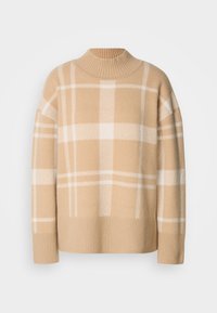 Pull à col roulé beige avec un motif à carreaux blancs, poignets et ourlet côtelés, présenté sur un fond clair uni.
