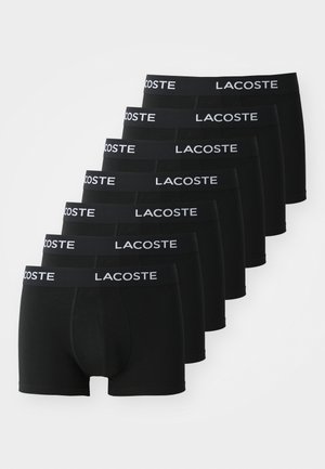 Black boxer shorts in a pack of seven, made of smooth fabric with a wide elastic waistband featuring the Lacoste logo in white.